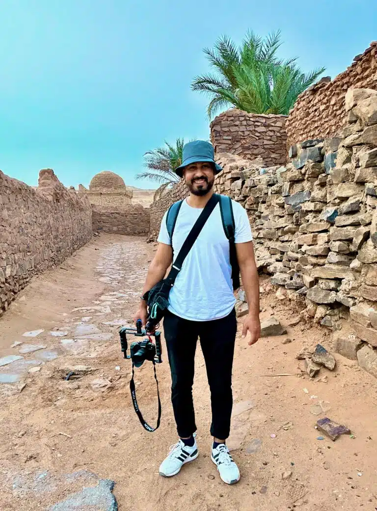 Majdi carrying a camera while traveling