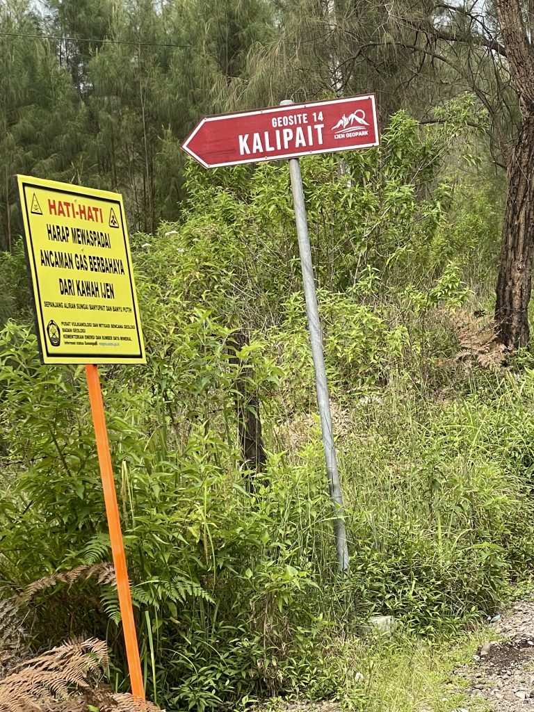 The red Geosite 14 Kalipait sign on the way to Kalipait Waterfall